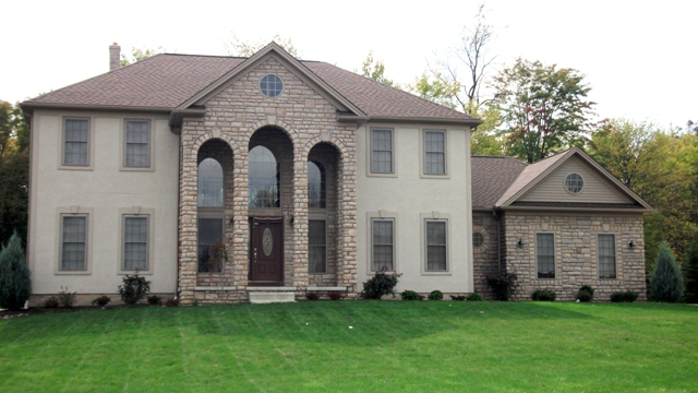 Large 2-story foyer and great room. 1st floor office/den. Round staircase. Large arched covered porch. Partial stone front. Dining room with tray ceiling. Large kitchen with breakfast bar. Arched display. Vaulted master bedroom. Large master walk-in closet. 1st floor laundry. 2-car side-entry garage with storage area.